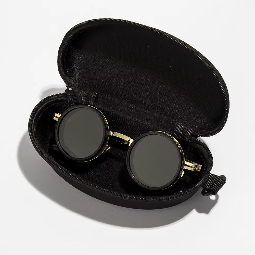 Black and gold goggles in a black case on a white background