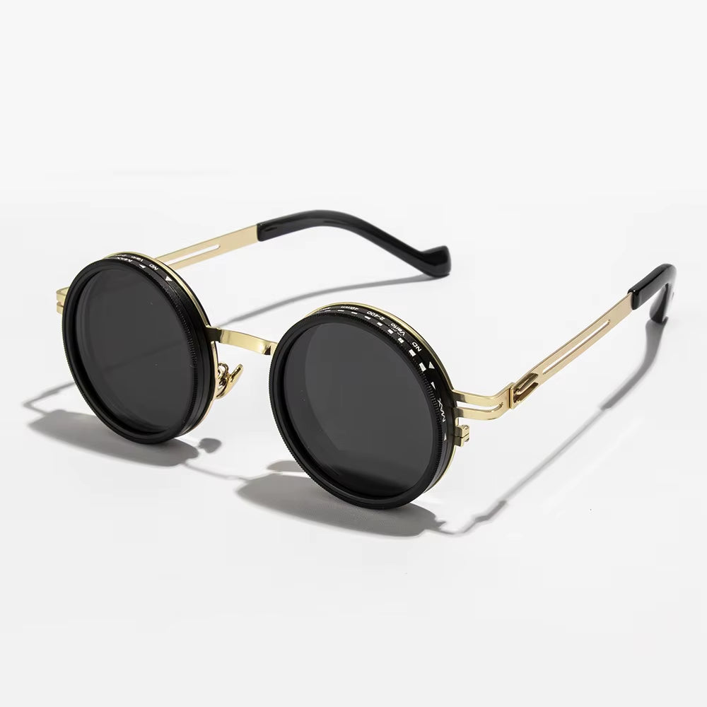 Round sunglasses with gold frame and black lenses on a white background