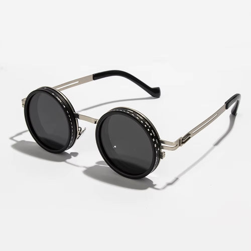Round sunglasses with black lenses and silver frames on a white background